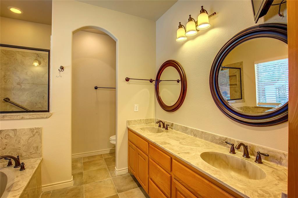 2617 Kirby Road Rowlett, TX 75088 - Photo 24 of 39 Full bathroom with a relaxing tiled tub, double vanity, and light tile patterned flooring