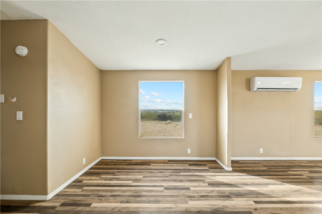 3649 Araby Road Golden Valley, AZ 86413 - Photo 18 of 29 Spacious room featuring wood-finish flooring, neutral-toned walls, and recessed lighting