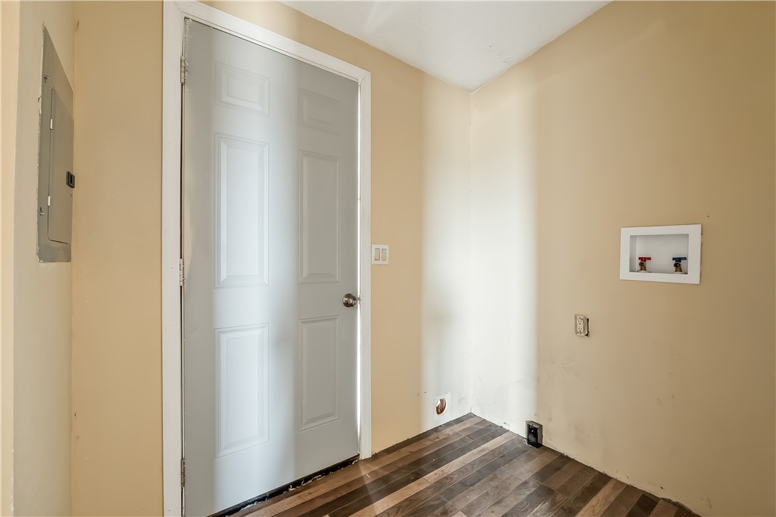3649 Araby Road Golden Valley, AZ 86413 - Photo 19 of 29 Utility area with wood-finish flooring, a paneled door, and a wall-mounted electrical panel