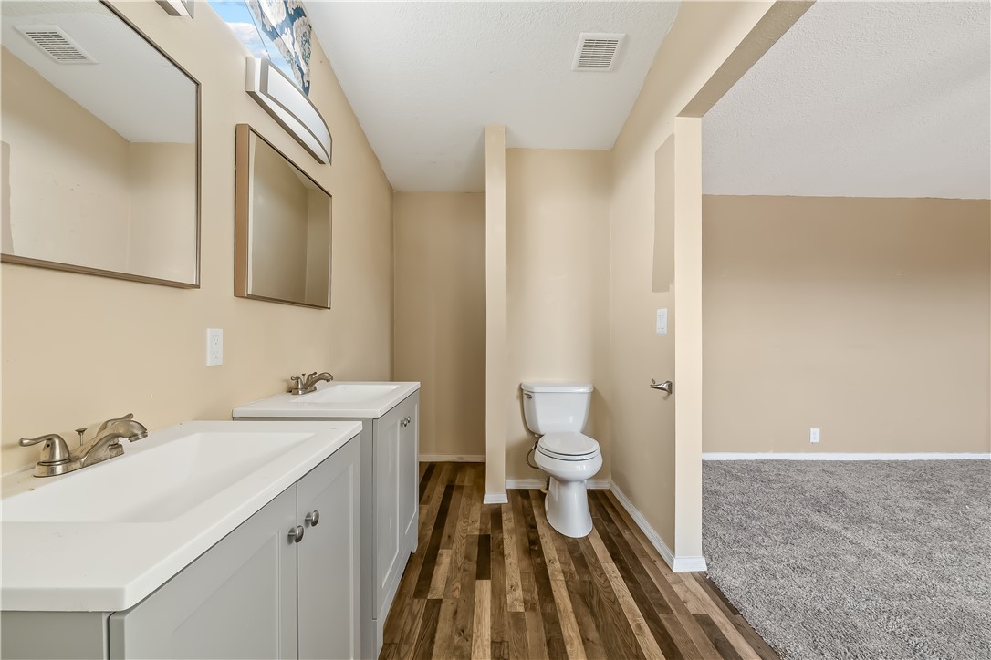 3649 Araby Road Golden Valley, AZ 86413 - Photo 24 of 29 Dual vanity featuring light gray cabinetry and integrated sinks with chrome fixtures