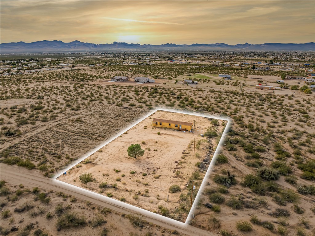3649 Araby Road Golden Valley, AZ 86413 - Photo 25 of 29 Expansive desert lot featuring a single residence, a mature tree, and surrounding natural landscape