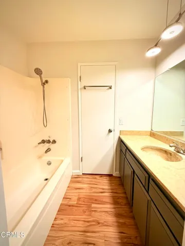 a bathroom with a tub and shower