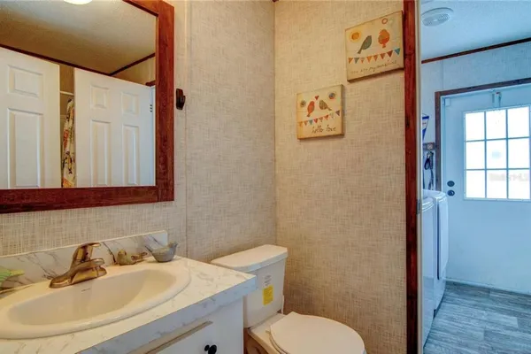 a bathroom with a sink mirror and toilet