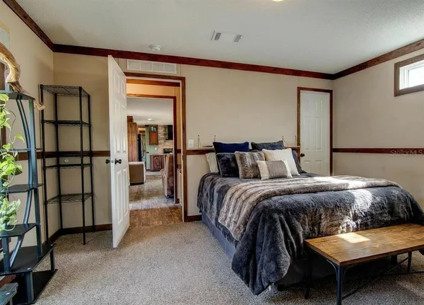 a bedroom with a bed and a painting on the wall