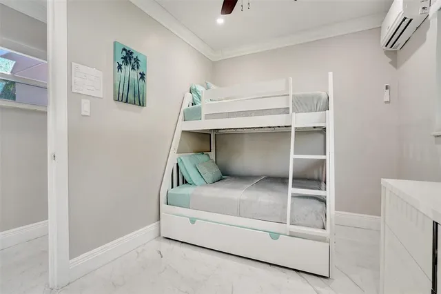 a bedroom with a bed and ceiling fan