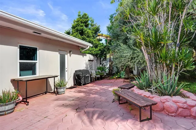 a view of a backyard with sitting area