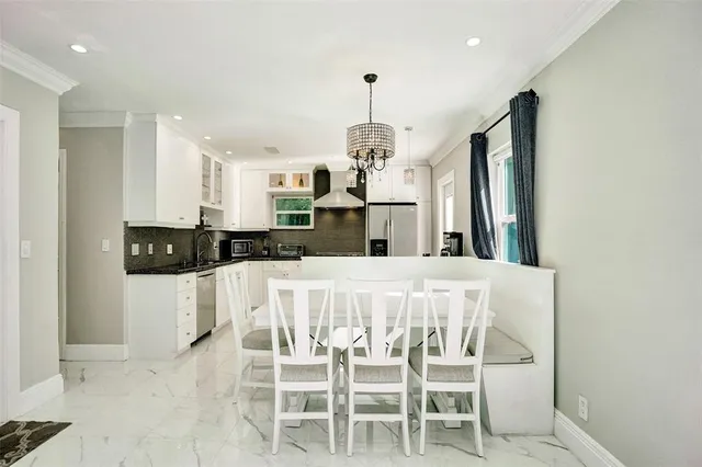 a kitchen with stainless steel appliances kitchen island granite countertop a refrigerator and microwave