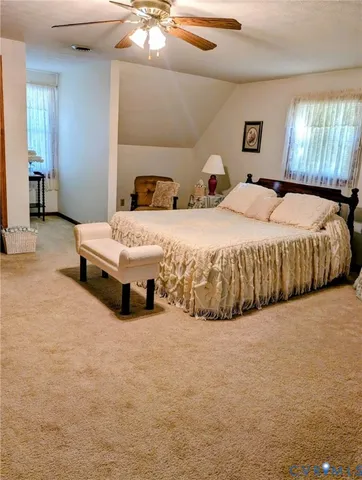 a spacious bedroom with a bed and window