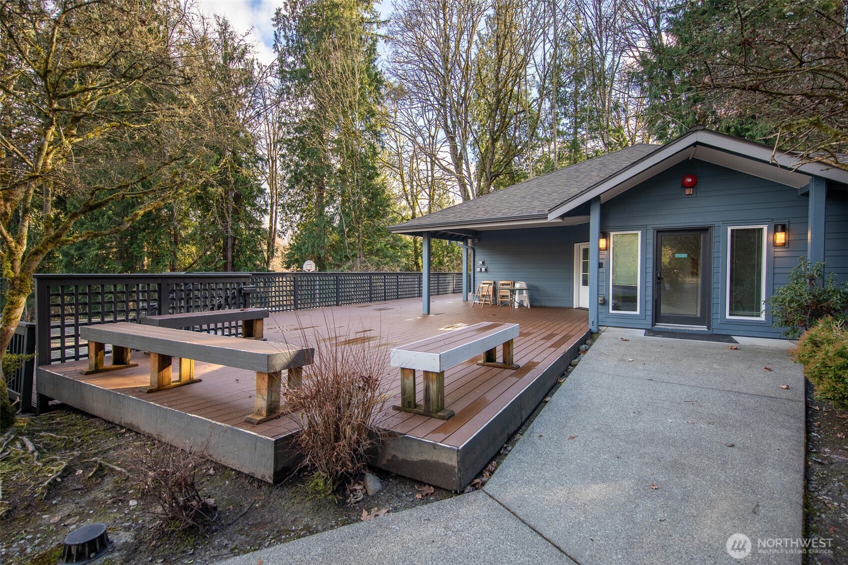 15917 Waynita Way Northeast, Unit E206 Bothell, WA 98011 - Photo 17 of 22 a view of a patio with table and chairs with wooden fence and floor