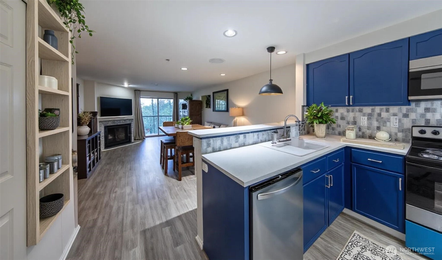 15917 Waynita Way Northeast, Unit E206 Bothell, WA 98011 - Photo 5 of 22 a kitchen with stainless steel appliances granite countertop a sink stove and wooden cabinets