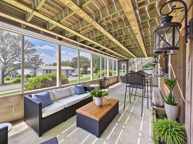 an aerial view of residential house with outdoor space and trees all around