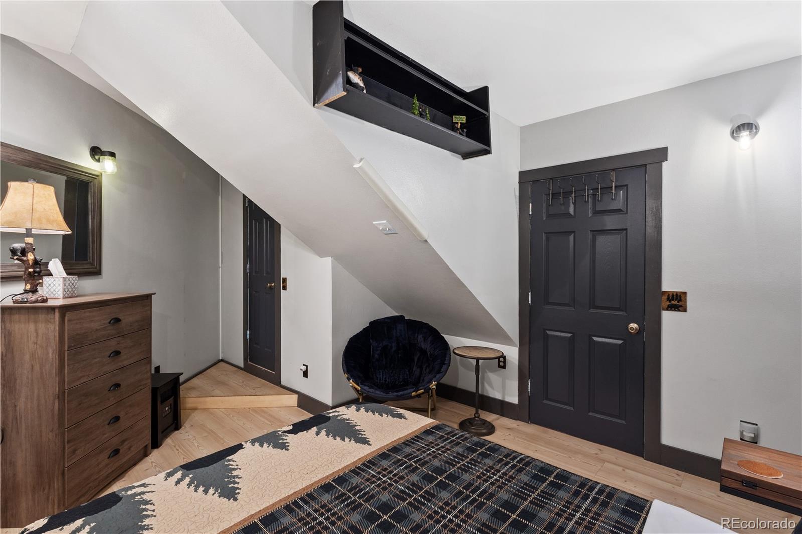 301 West 3rd Street Creede, CO 81130 - Photo 11 of 24 a bedroom with a bed and a dresser