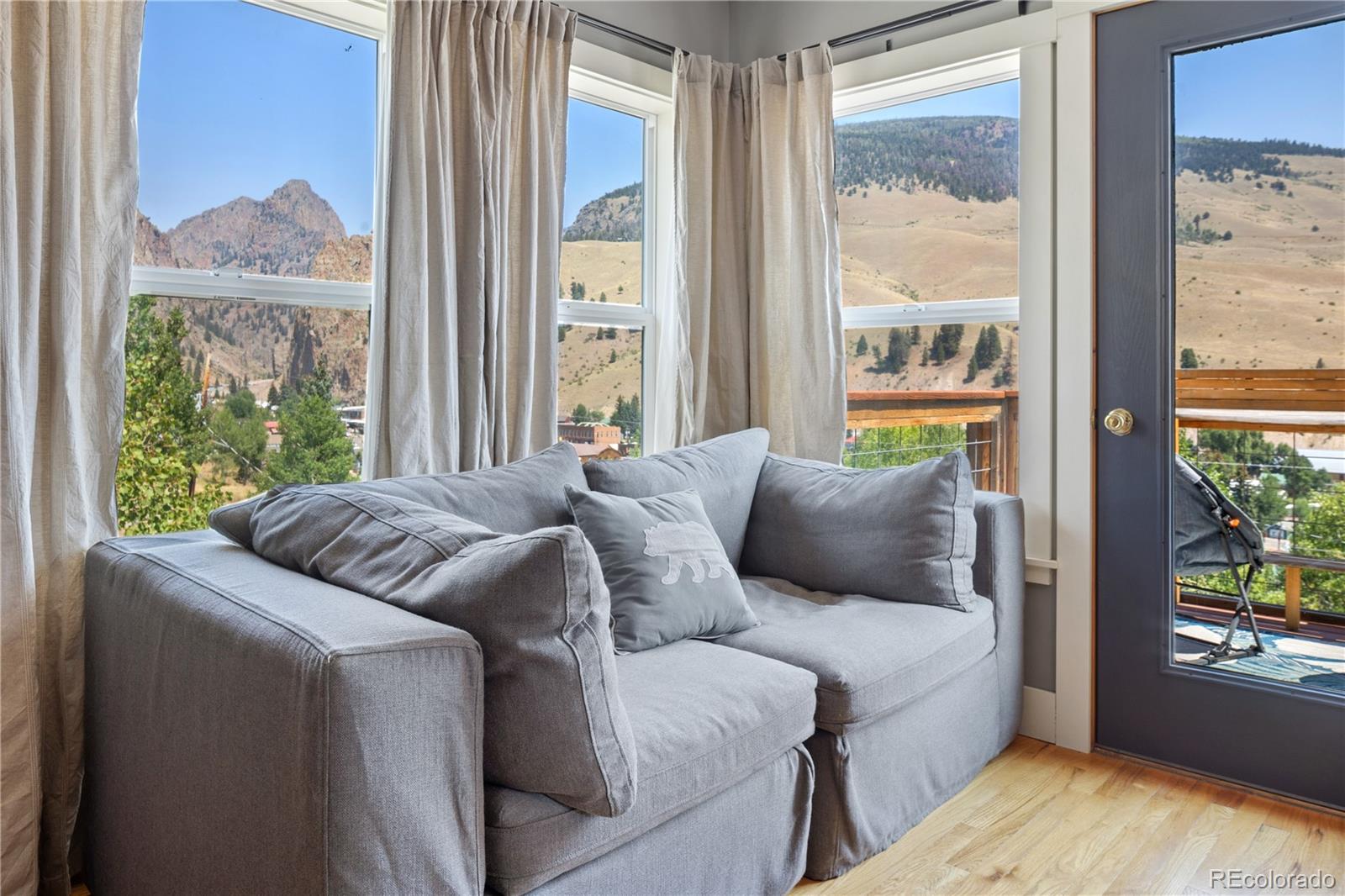 301 West 3rd Street Creede, CO 81130 - Photo 13 of 24 a living room with a bed couch and a window