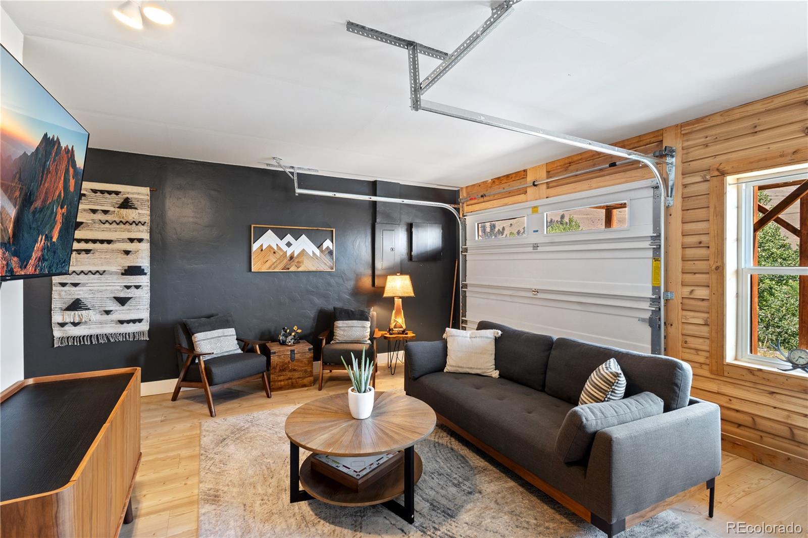 301 West 3rd Street Creede, CO 81130 - Photo 20 of 24 a living room with furniture and a chandelier