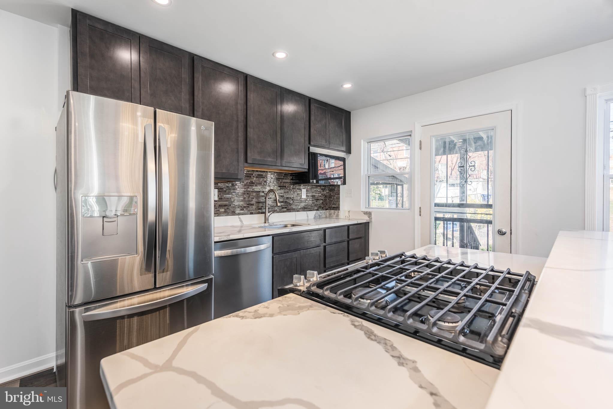 1510 Northbourne Road Baltimore, MD 21239 - Photo 11 of 32 a kitchen with stainless steel appliances a refrigerator and a stove top oven