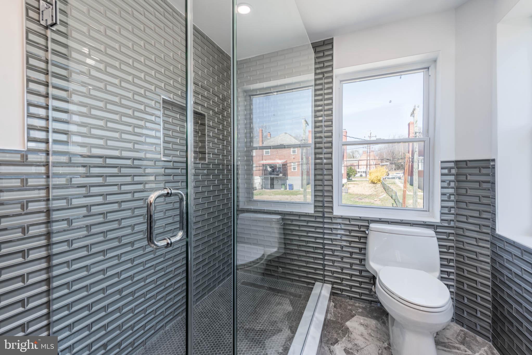 1510 Northbourne Road Baltimore, MD 21239 - Photo 17 of 32 a bathroom with a toilet and a shower