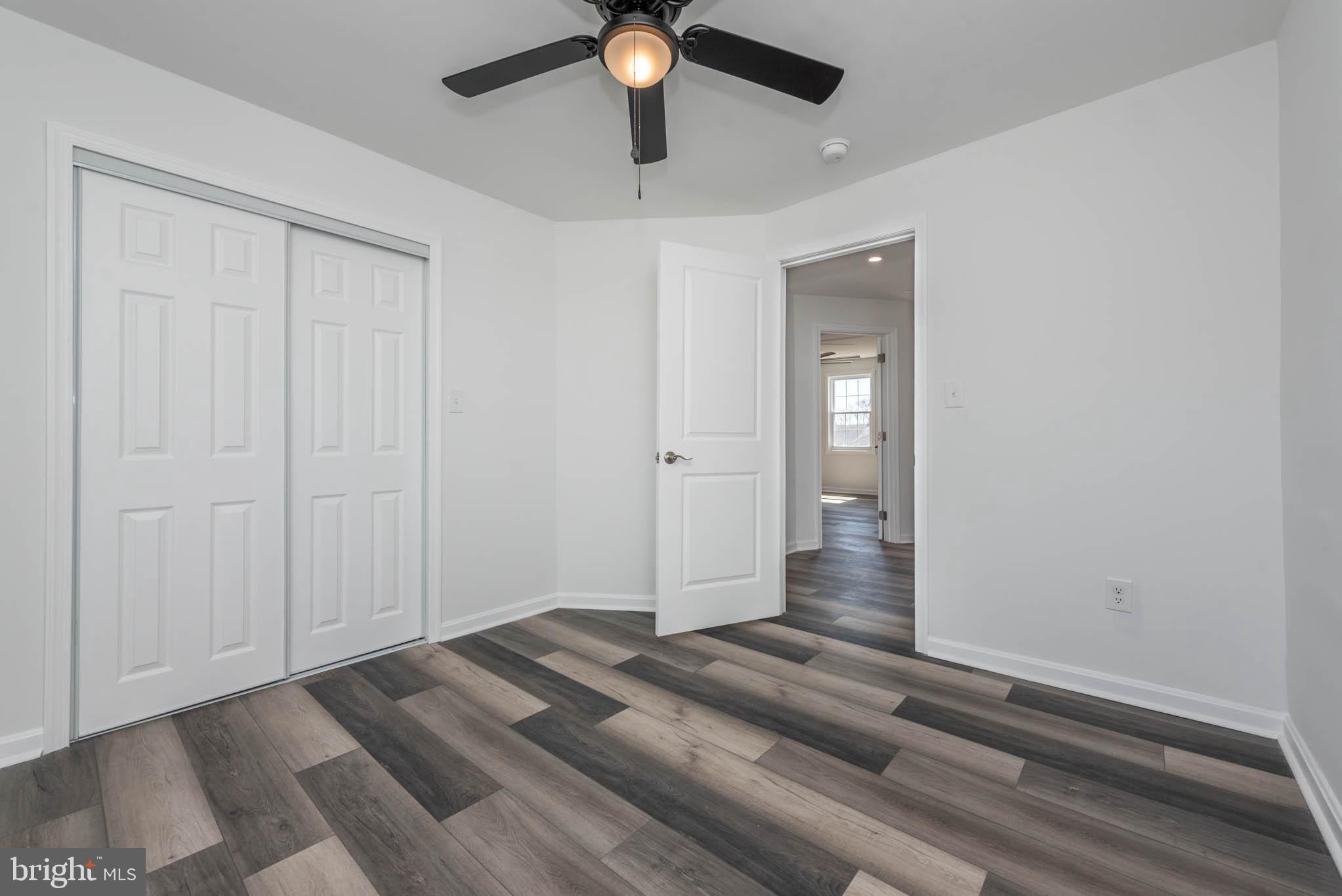 1510 Northbourne Road Baltimore, MD 21239 - Photo 19 of 32 wooden floor in an empty room with a window