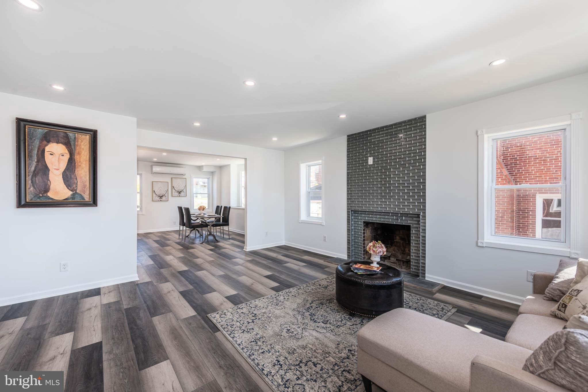 1510 Northbourne Road Baltimore, MD 21239 - Photo 2 of 32 a living room with furniture and a fireplace