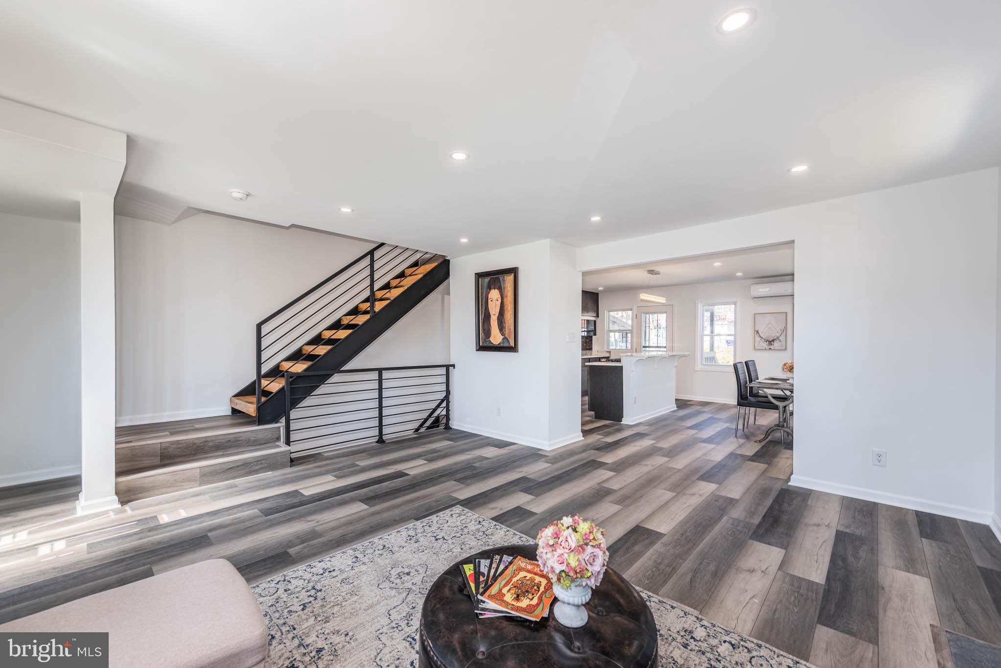 1510 Northbourne Road Baltimore, MD 21239 - Photo 4 of 32 a view of a livingroom with wooden floor and stairs