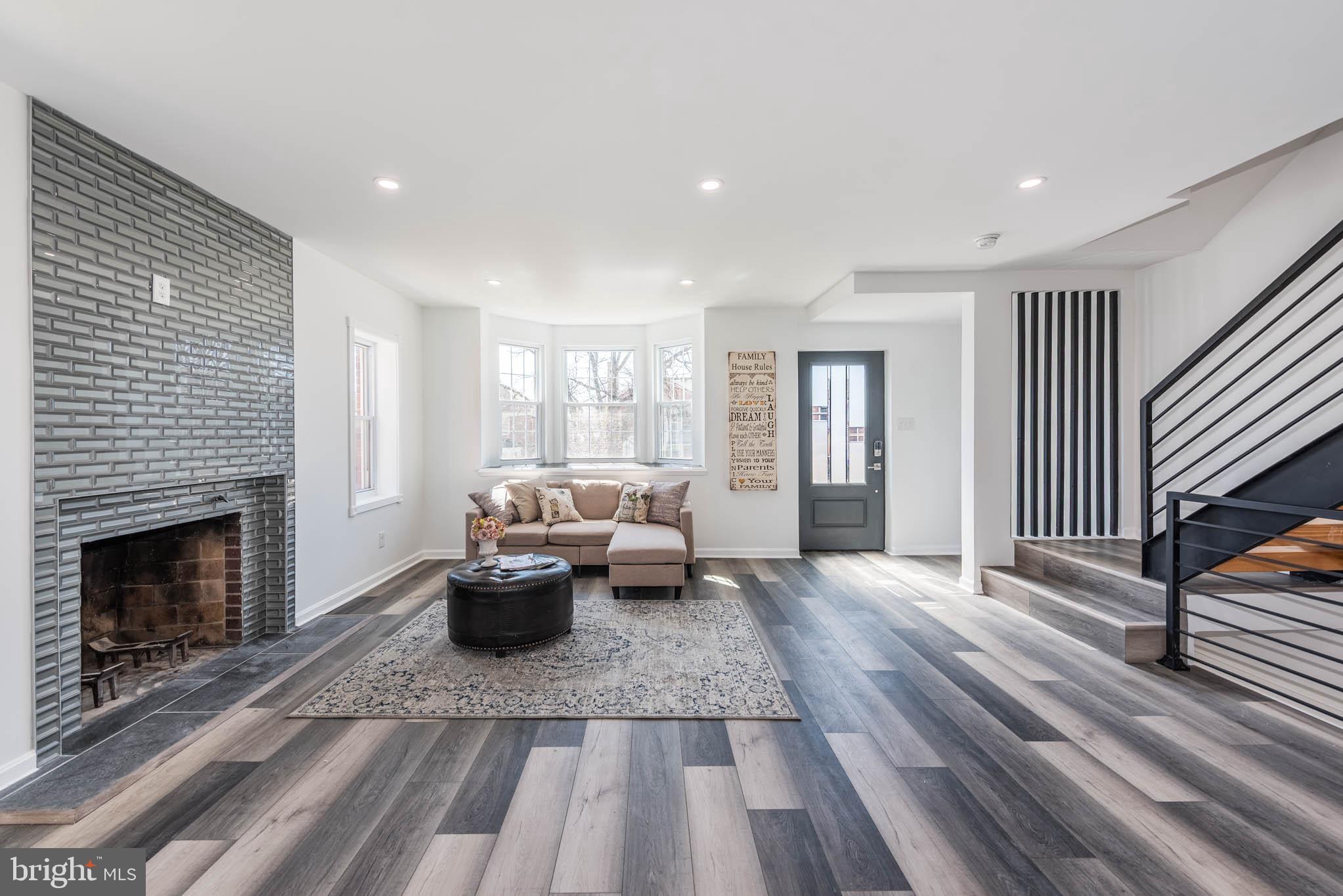 1510 Northbourne Road Baltimore, MD 21239 - Photo 5 of 32 a living room with furniture and a fireplace