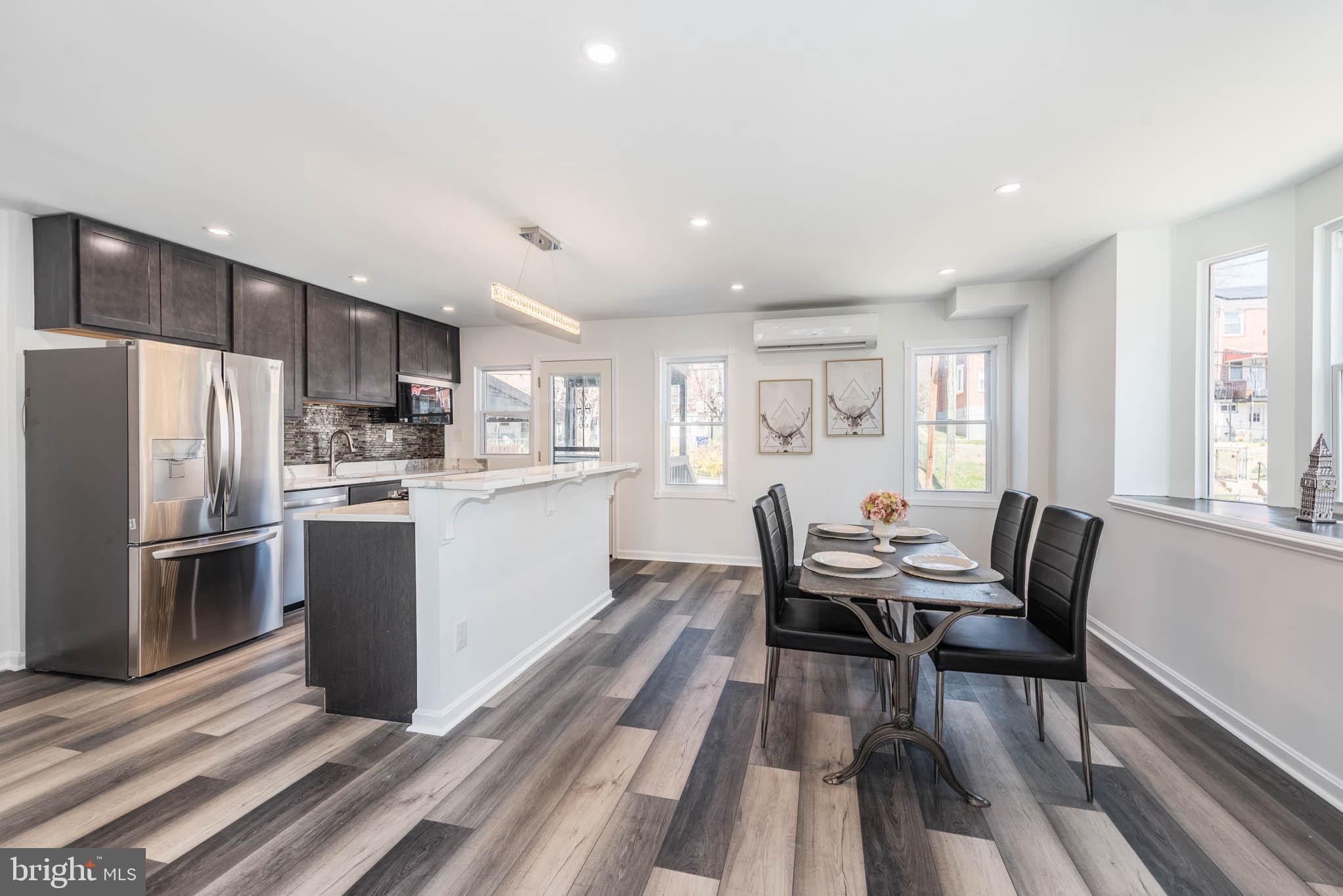 1510 Northbourne Road Baltimore, MD 21239 - Photo 6 of 32 a kitchen with a table chairs refrigerator and window