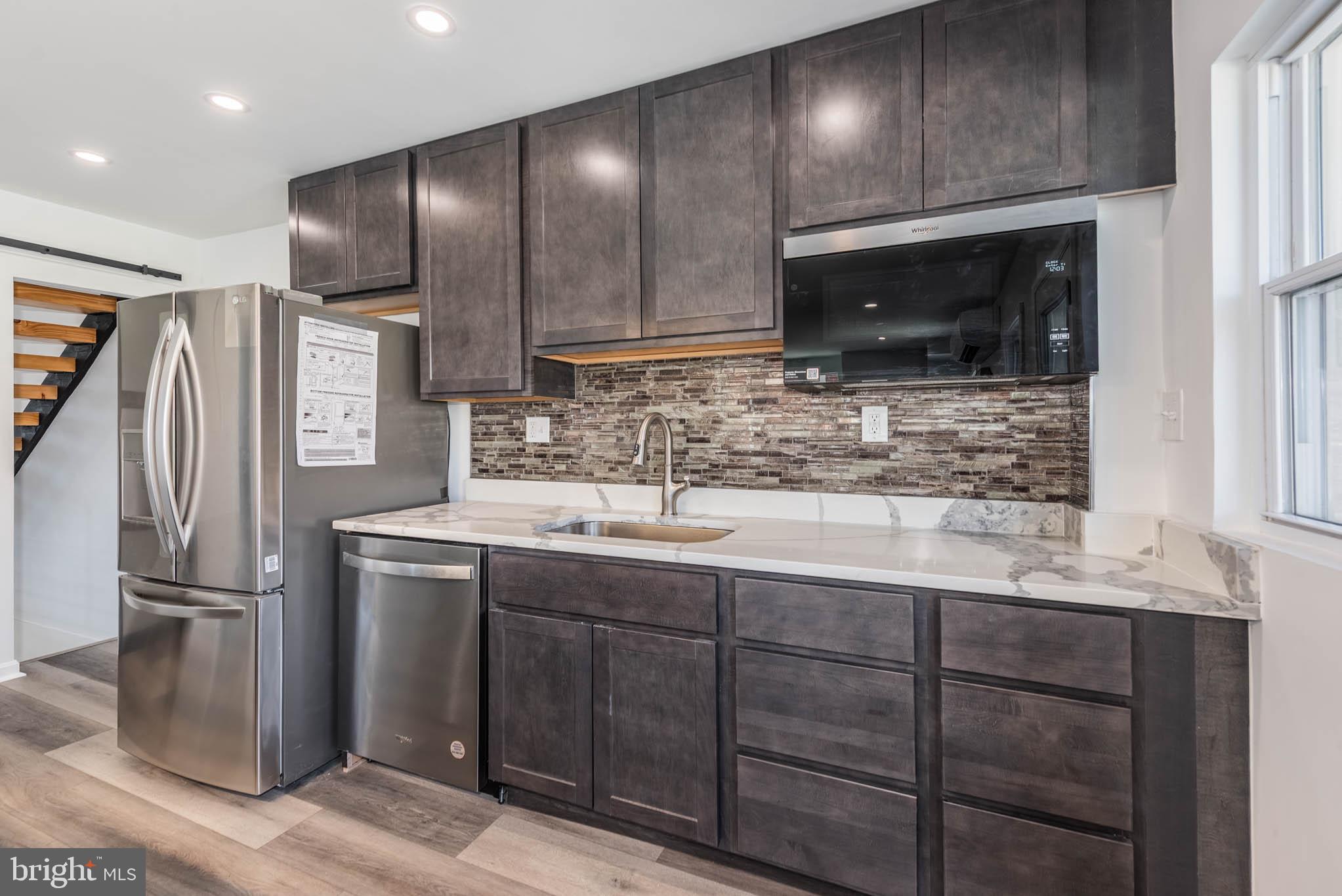 1510 Northbourne Road Baltimore, MD 21239 - Photo 9 of 32 a kitchen with stainless steel appliances granite countertop a refrigerator and a sink