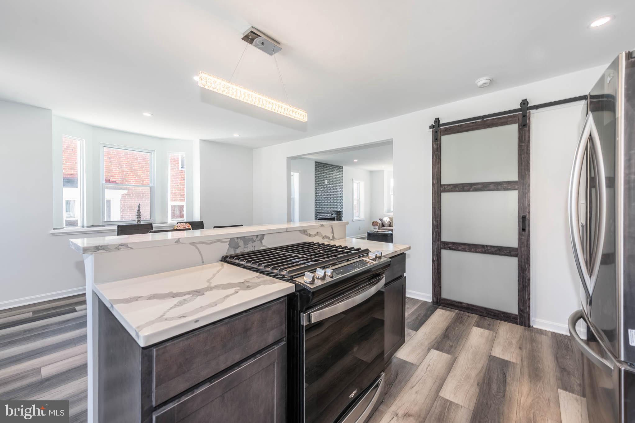 1510 Northbourne Road Baltimore, MD 21239 - Photo 10 of 32 a kitchen with a stove a refrigerator and a sink