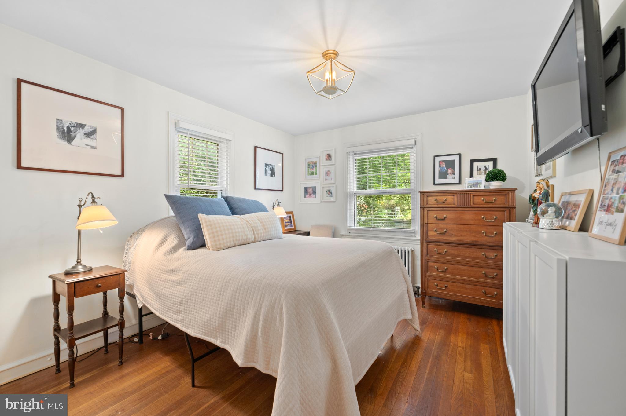 1242 Old Lancaster Road Berwyn, PA 19312 - Photo 15 of 42 a bed room with a bed and a chandelier