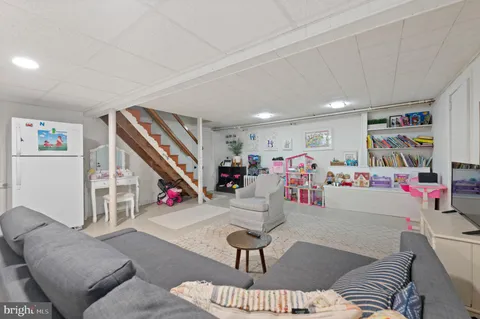 a living room with lots of furniture and a book shelf