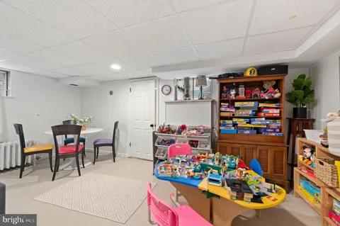 a room with lots of baby toys and hanging chair