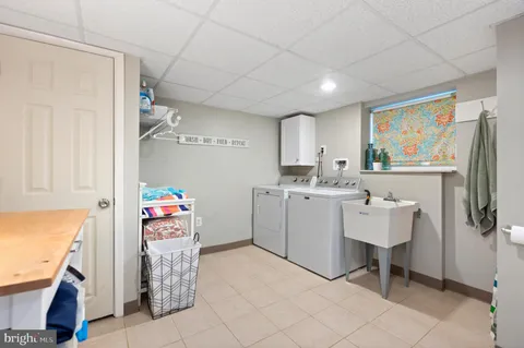 a utility room with cabinets dryer and washer