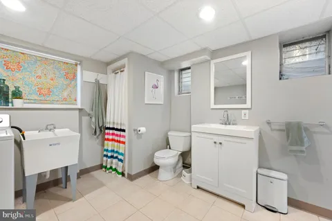 a bathroom with a sink mirror vanity and toilet