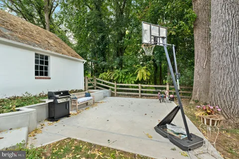 a view of backyard with two chair and potted plants