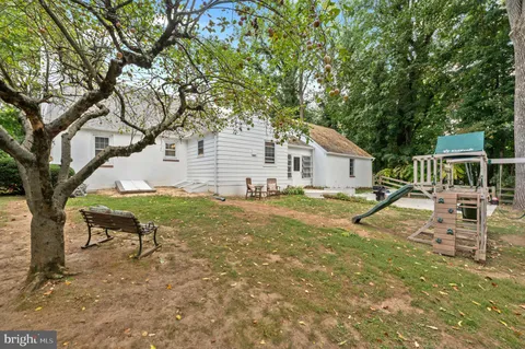 a view of a house with backyard and sitting area