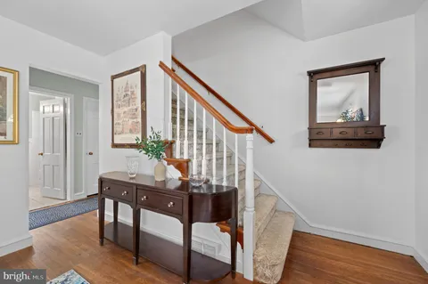 a view of an entryway with wooden floor and stairs