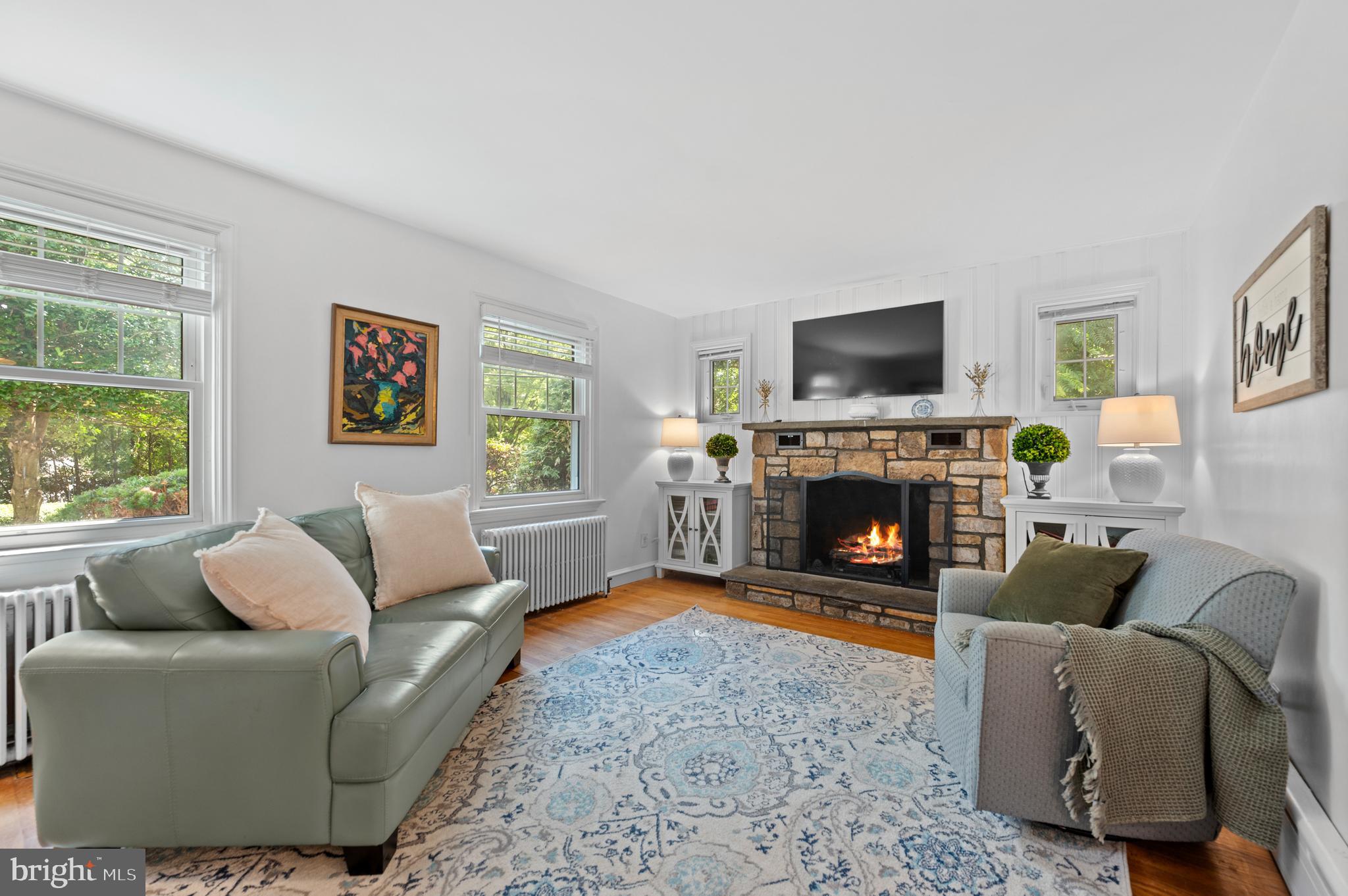 1242 Old Lancaster Road Berwyn, PA 19312 - Photo 7 of 42 a living room with furniture a flat screen tv and a fireplace