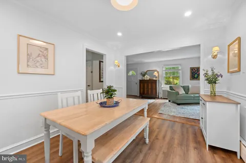 a view of a kitchen area with furniture and wooden floor
