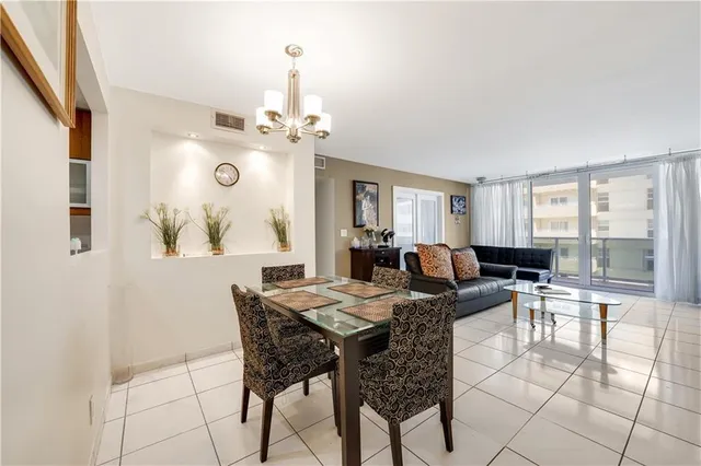 a view of a dining room with furniture and a chandelier