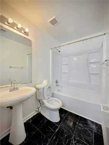 a bathroom with a sink toilet a mirror and shower