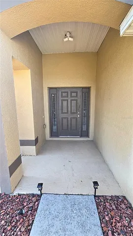 a kitchen with a refrigerator sink and cabinets