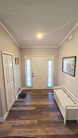an empty room with wooden floor and a window