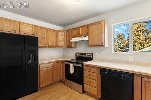 a kitchen with a stove a sink and a microwave