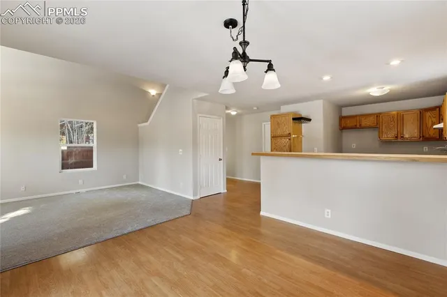 a view of a kitchen with a sink cabinets and wooden floor