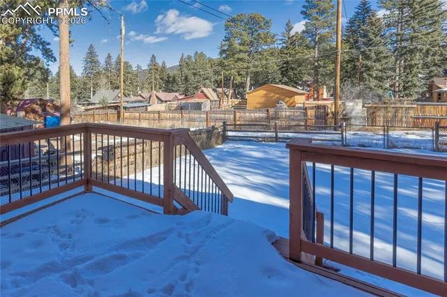 a view of balcony with wooden floor and fence
