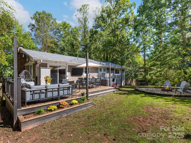 a view of a house with swimming pool and sitting area