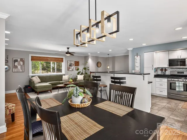 a living room with furniture kitchen view and a window