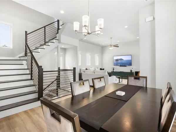 a living room with furniture a rug and a chandelier