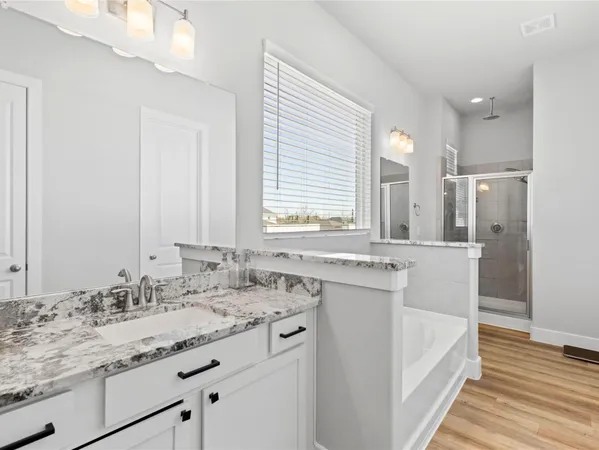a bathroom with a double vanity sink and mirror