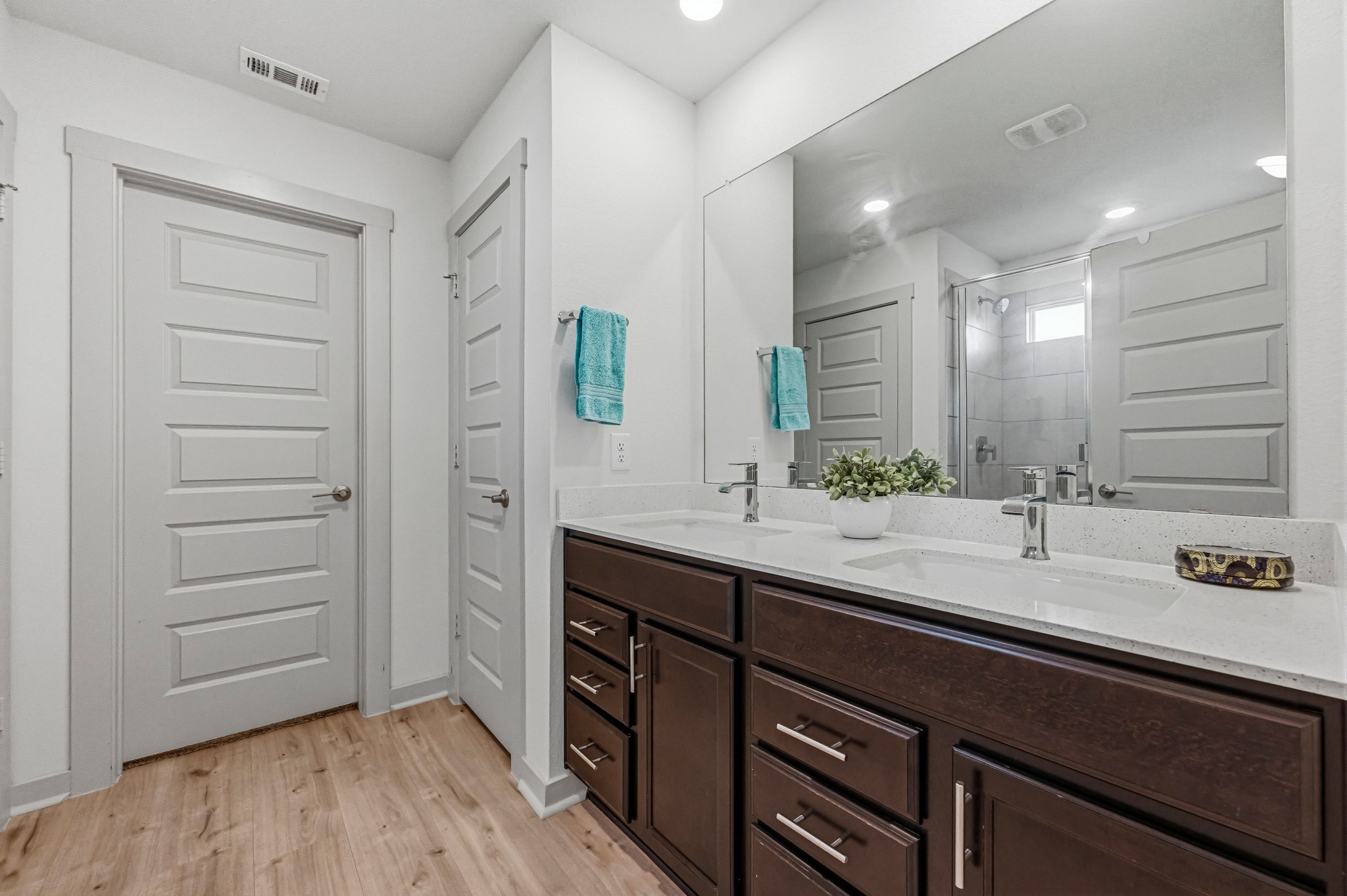 7511 Traylor Cove Austin, TX 78724 - Photo 16 of 40 a bathroom with a sink a mirror and a shower