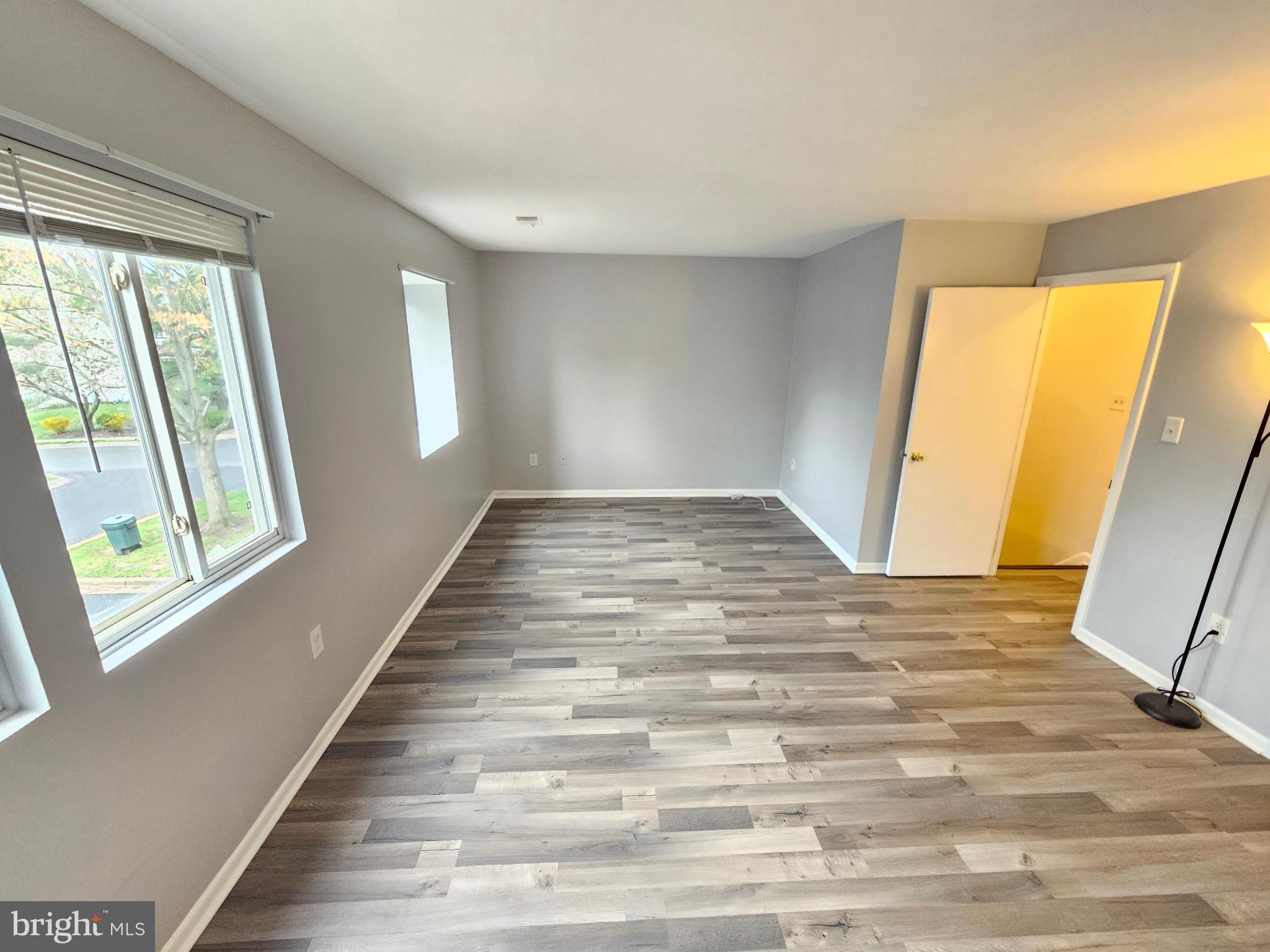 17445 Hoskinson Road Poolesville, MD 20837 - Photo 22 of 37 a view of an empty room with wooden floor and a window
